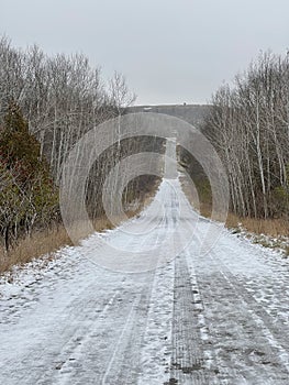 Long straight icy snowy road
