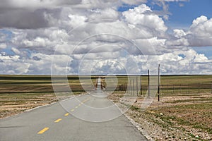 A long straight road leads to the horizon ahead