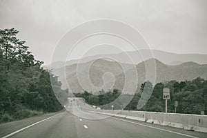 Long straight road with mountain view of countryside