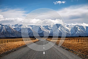 Long straight road towards a mountain in New Zealand