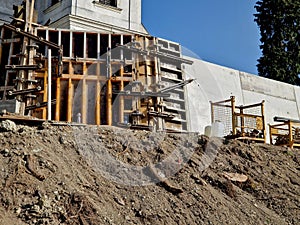 long straight supporting wall of cast cement mixer formwork.