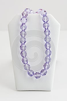 Long strand of large oblong faceted purple beads