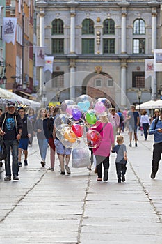 Long street with Golden Gate, street life, colored balloons, Gdansk, Poland