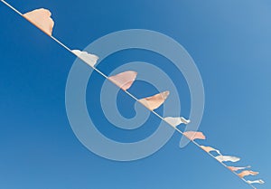 A long string of flags is hanging in the sky