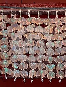 A long string of white beads with a red background