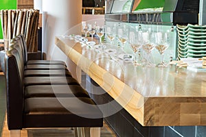 Long table with glasses in the cozy cafe