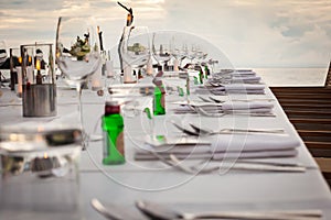 Long table wedding dinner setup on the beach.