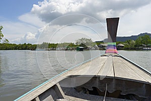Long tail boat against blue sky in Phang Nga Bay