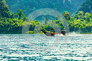 Long Tail Boat Cheow Lan Lake Khao Sok National Park Thailand. Mountain scenery on tropical lake landscape