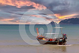 Long tail Boat on colourful sunset over Patong Beach Phuket Thailand