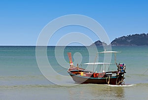 Long tail Boat on colourful sunset over Patong Beach Phuket Thailand