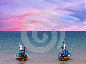 Long tail Boat on colourful sunset over Patong Beach Phuket Thailand