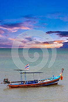 Long tail Boat on colourful sunset over Patong Beach Phuket Thailand