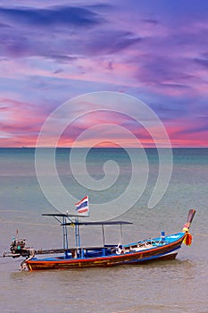 Long tail Boat on colourful sunset over Patong Beach Phuket Thailand