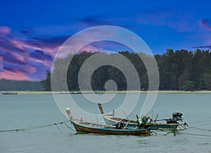 Long tail Boat on colourful sunset over Patong Beach Phuket Thailand