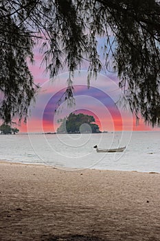 Long tail Boat on colourful sunset over Patong Beach Phuket Thailand