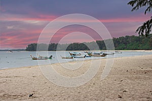 Long tail Boat on colourful sunset over Patong Beach Phuket Thailand