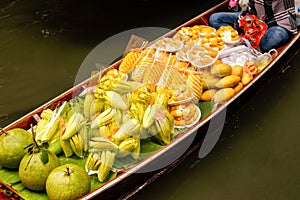 Long-tail boat with fruits on the floating market, Damnoen Saduak floating market in Ratchaburi near Bangkok, Thailand