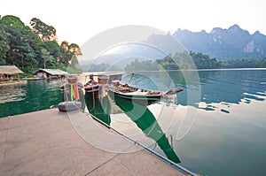 Long-tail boat and lakeside raft houses on Cheow Lan Lake, Khao