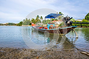 Long-tail boat of local Thai fisherman parked in the bay