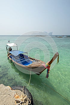 Long-tail boat moored to port on a sunny day