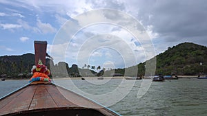 Long tail boat taking tourist to Phi Phi islands resort beach Thailand Phuket world travel destination