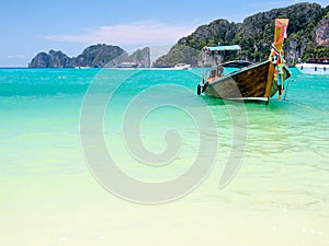 Long tail boats with crystal clear water in sunny day