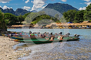 Long tail boats on sunset at Song river, Vang Vieng, Laos. photo