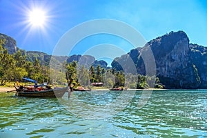 Long tail boats on tropical beach with palms, Tonsai Bay, Railay