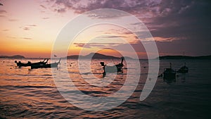 Long-tail fishing boats on Rawai beach at Phuket Thailand in sunrise