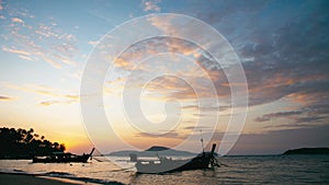 Long-tail fishing boats on Rawai beach at Phuket Thailand in sunrise