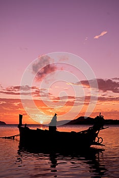 Long tail fishing boats at sunet