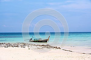 Long tailed boats near tropical beach at Ko Phi Phi, Thailand. Tropic beach with white sand and turquoise water, concept of