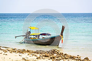 Long tailed boats near tropical beach at Ko Phi Phi, Thailand. Tropic beach with white sand and turquoise water, concept of