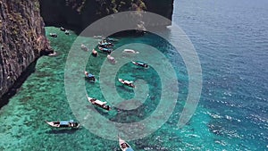 Long tailed boats in turquoise tropical sea in Thailand. Aerial View