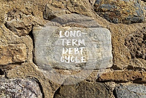 Long-term debt cycle symbol. Concept words Long-term debt cycle on beautiful big grey stone. Beautiful stone wall background.