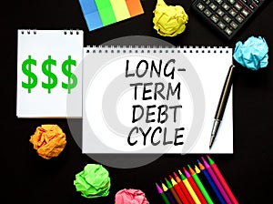 Long-term debt cycle symbol. Concept words Long-term debt cycle on beautiful white note. Beautiful black table black background.