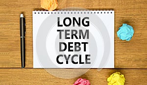 Long term debt cycle symbol. Concept words Long term debt cycle on beautiful white note. Beautiful wooden table background.