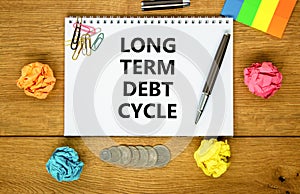 Long term debt cycle symbol. Concept words Long term debt cycle on beautiful white note. Beautiful wooden table background.