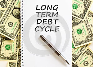 Long term debt cycle symbol. Concept words Long term debt cycle on beautiful white note. Black pen. Beautiful dollar bills