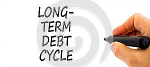 Long-term debt cycle symbol. Concept words Long-term debt cycle on beautiful white paper. Beautiful white background. Voter hand.