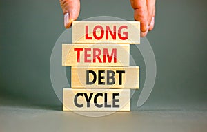 Long term debt cycle symbol. Concept words Long term debt cycle on beautiful wooden block. Beautiful grey table grey background.