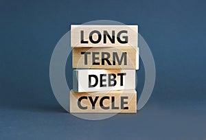 Long term debt cycle symbol. Concept words Long term debt cycle on beautiful wooden block. Beautiful grey table grey background.