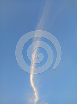 Long thin clouds against the background of a bright blue sky