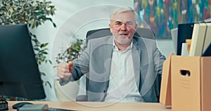 Long-time experienced boss of company in old age with gray hair retires promoted on desk there is box with packed things