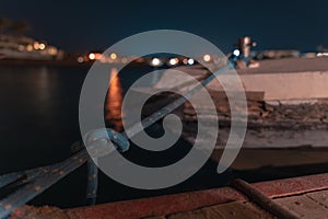 Long time exposure of a boat in El gouna lagoon with a view of a hotel in the night and stars in the air.