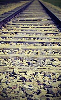 Long train tracks leading to infinity with photo effect