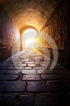 Long tunnel on the sunshine background in Casco Antiguo, Caceres, Extremadura, Spain photo