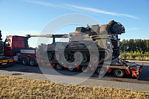 Long vehicle. Over-standard, atypical road transport. A howitzer on the tank chassis. Exceptional convoy photo