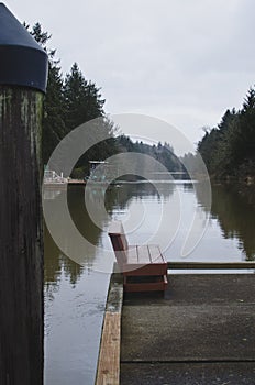 A long view of the lone bench on the river